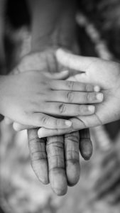 grayscale photo of man, woman and child's hands