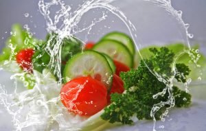 water splashing over vegetables