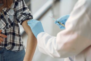 Provider about to give a vaccine to a young girl